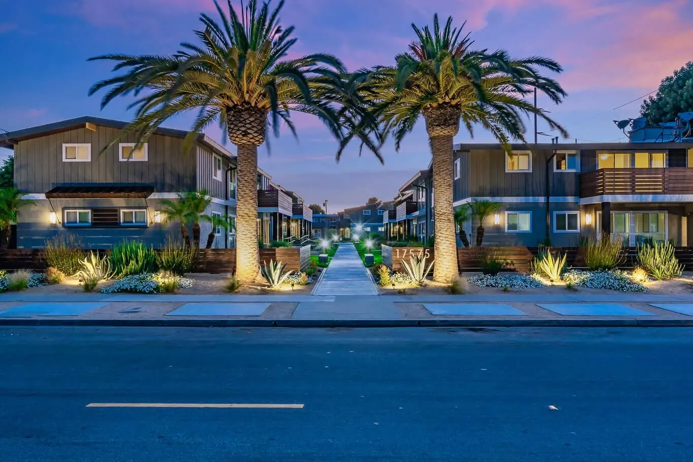 Palm lined walkway between renovated apartment buildings at Palm View Village in Torrance, CA